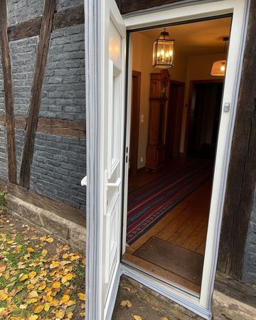A white exterior door with new weatherstripping along the jamb